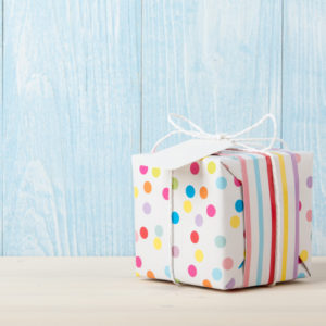 Polka dot gift box on wooden table